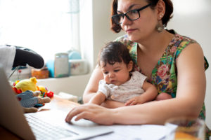 Working mom with baby in a lap