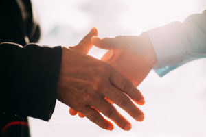 Close-up of male and female hands shaking.